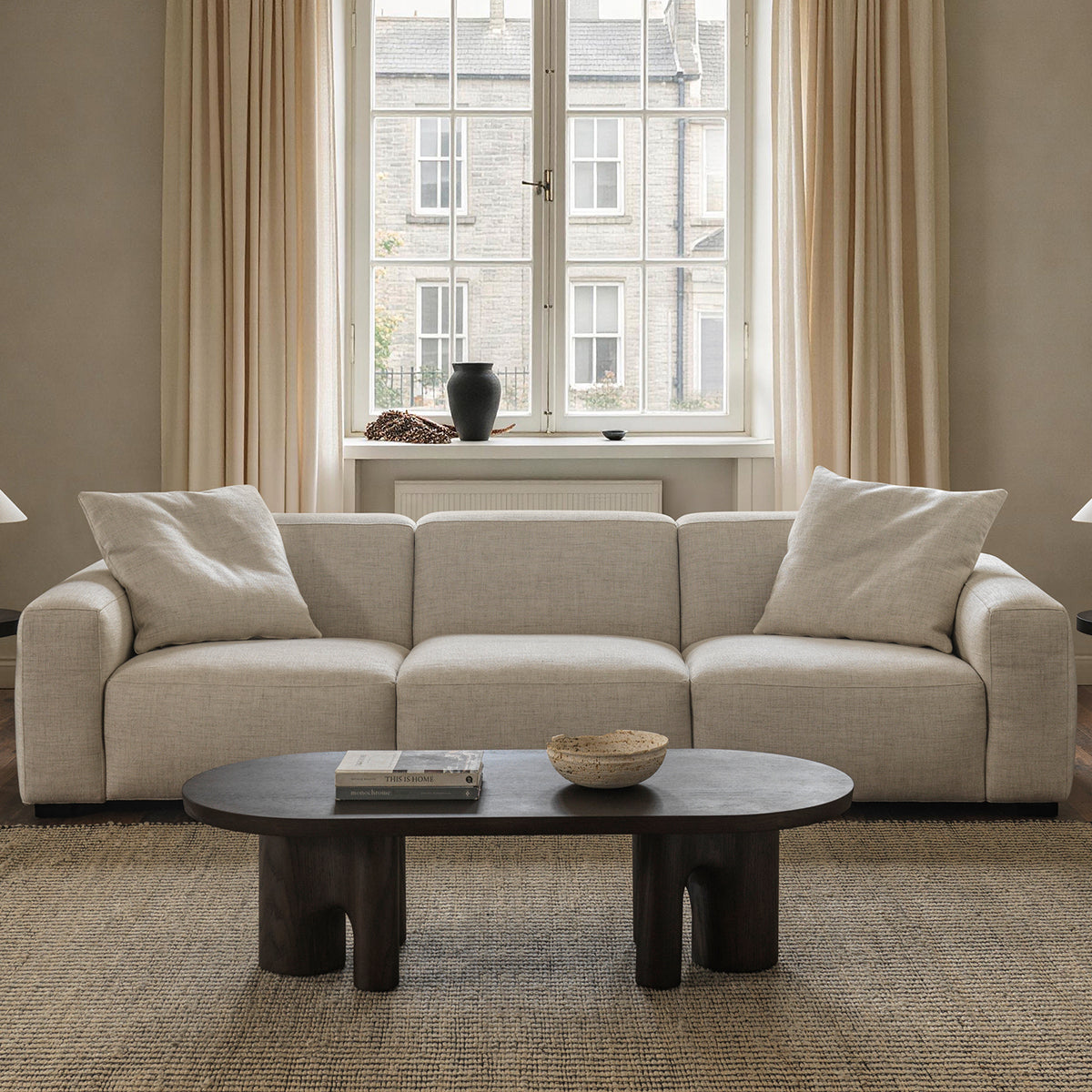 Cream cotton-linen rounded arm sofa in living room