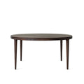 Front view of vintage distressed wood round dining table with solid timber legs