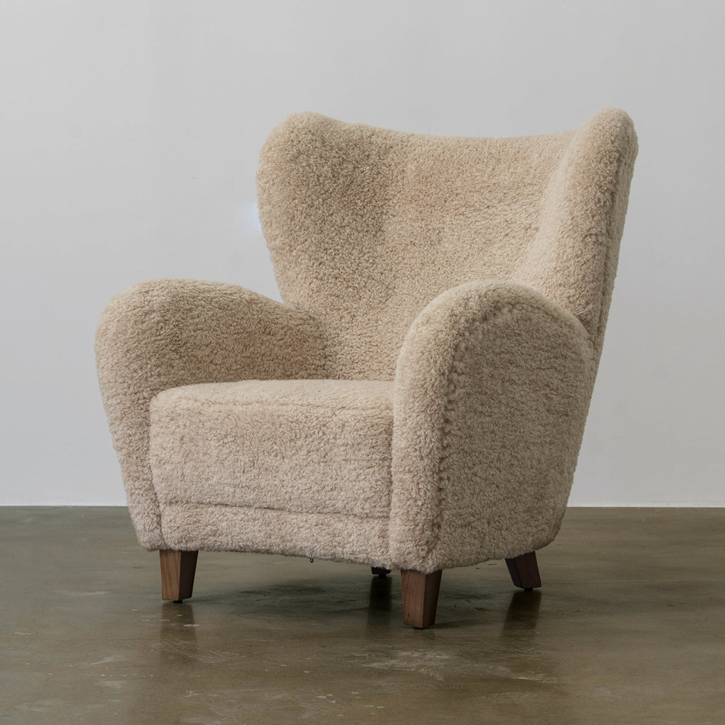 Youran beige fabric high-back lounge chair with rounded arms, three-quarter front view