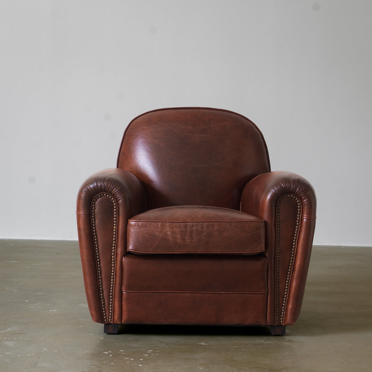 Vintage brown club chair three-quarter view