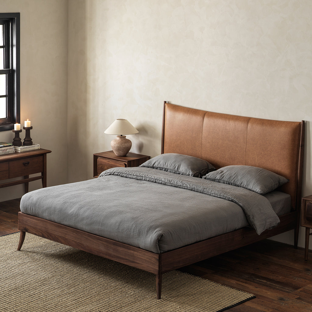 Black walnut bed with vintage leather headboard three-quarter view