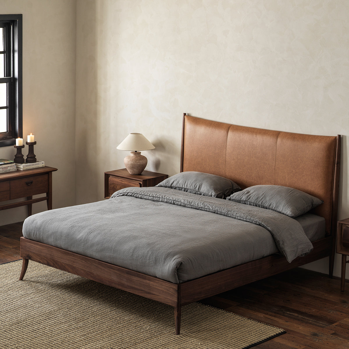 Black walnut bed with vintage leather headboard three-quarter view