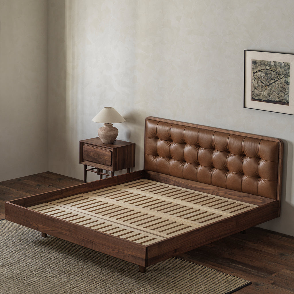 Solid black walnut bed frame with button-tufted leather headboard