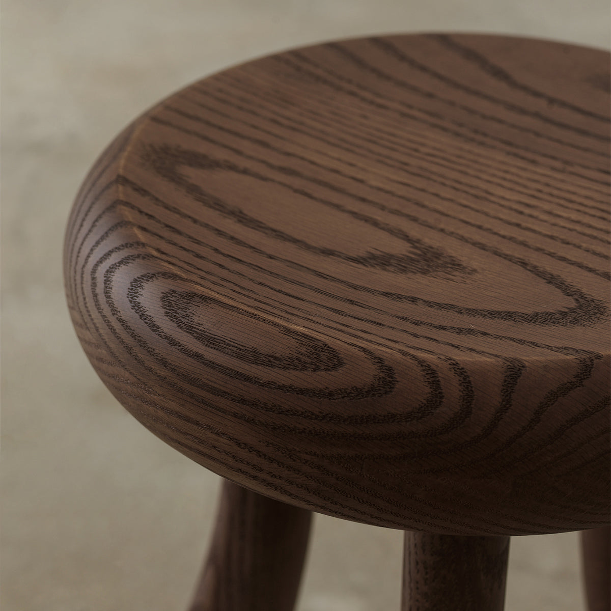 Macro close-up of rounded solid red oak tabletop showing deep-brushed wood grain and textured finish