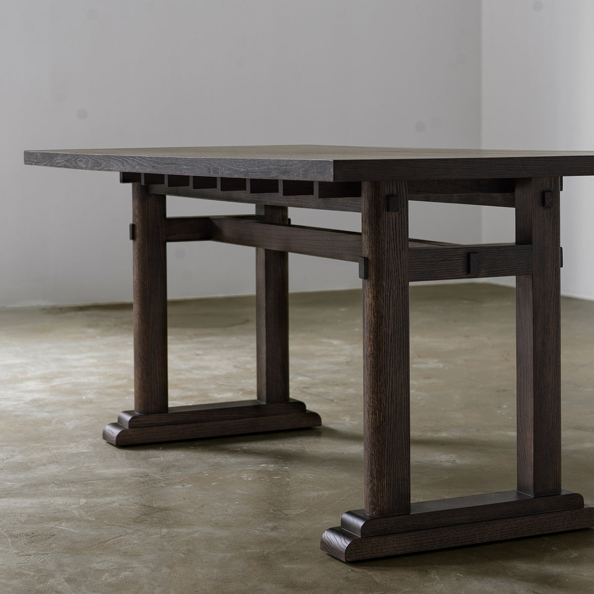 Distressed wooden dining table showing thick wood veneer top three-quarter view