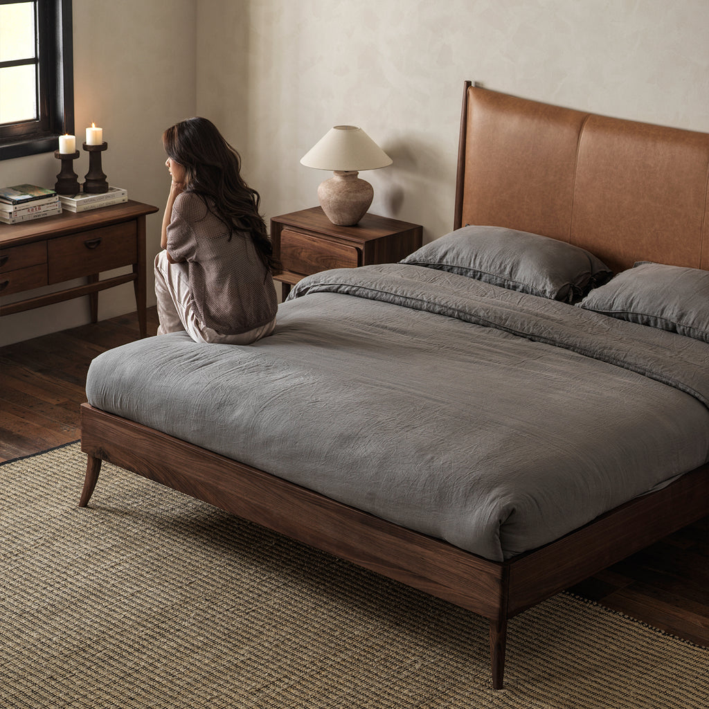 Warm brown leather headboard and black walnut bed in bedroom