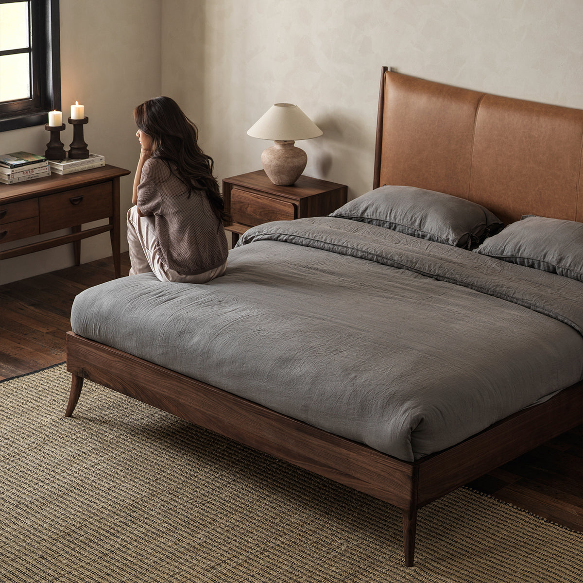 Warm brown leather headboard and black walnut bed in bedroom