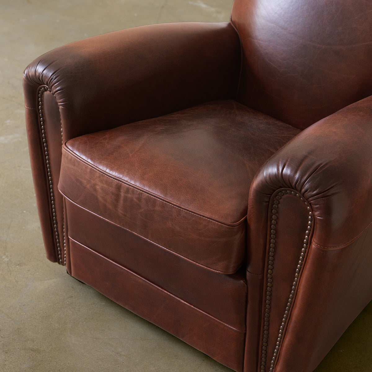 Brown club chair rolled arm and seat detail