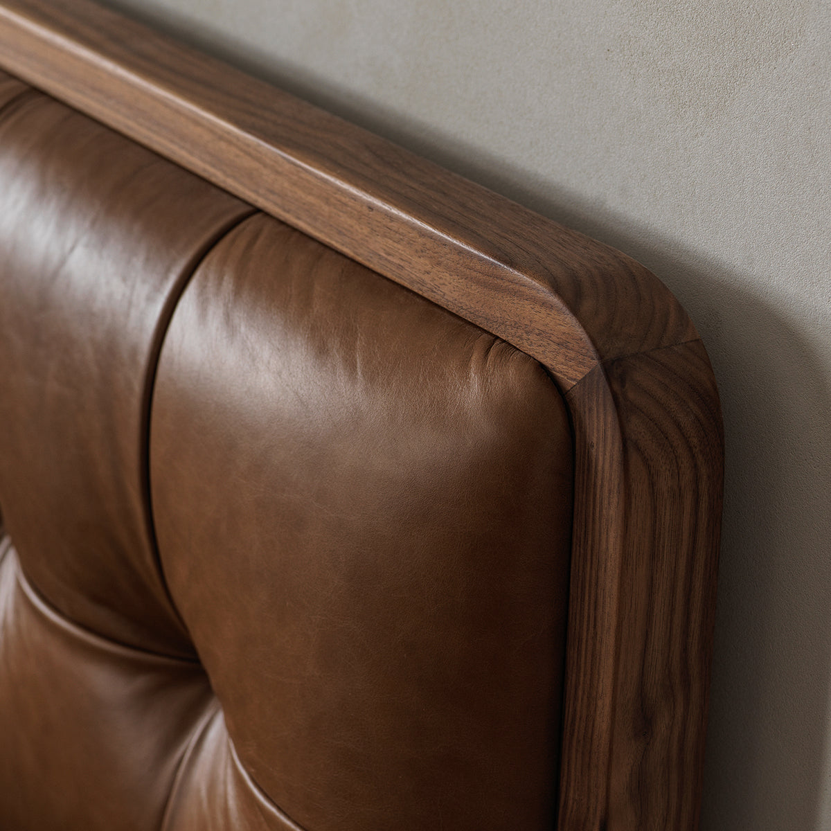 Solid black walnut bed frame with button-tufted leather headboard