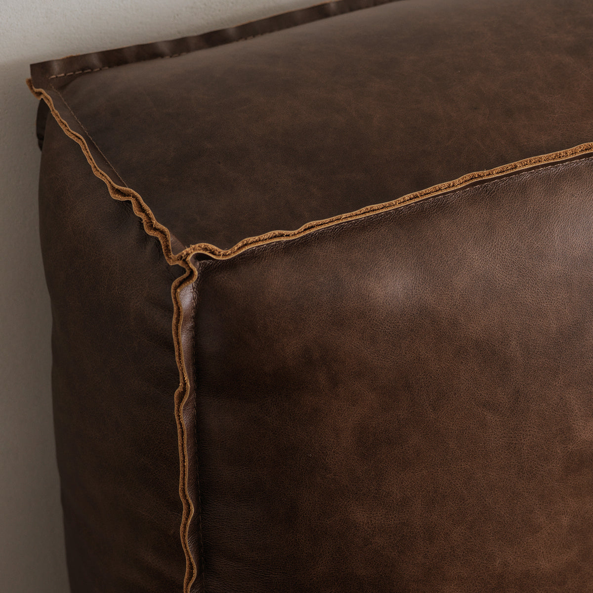 Vintage cowhide leather bed upholstery and seam detail