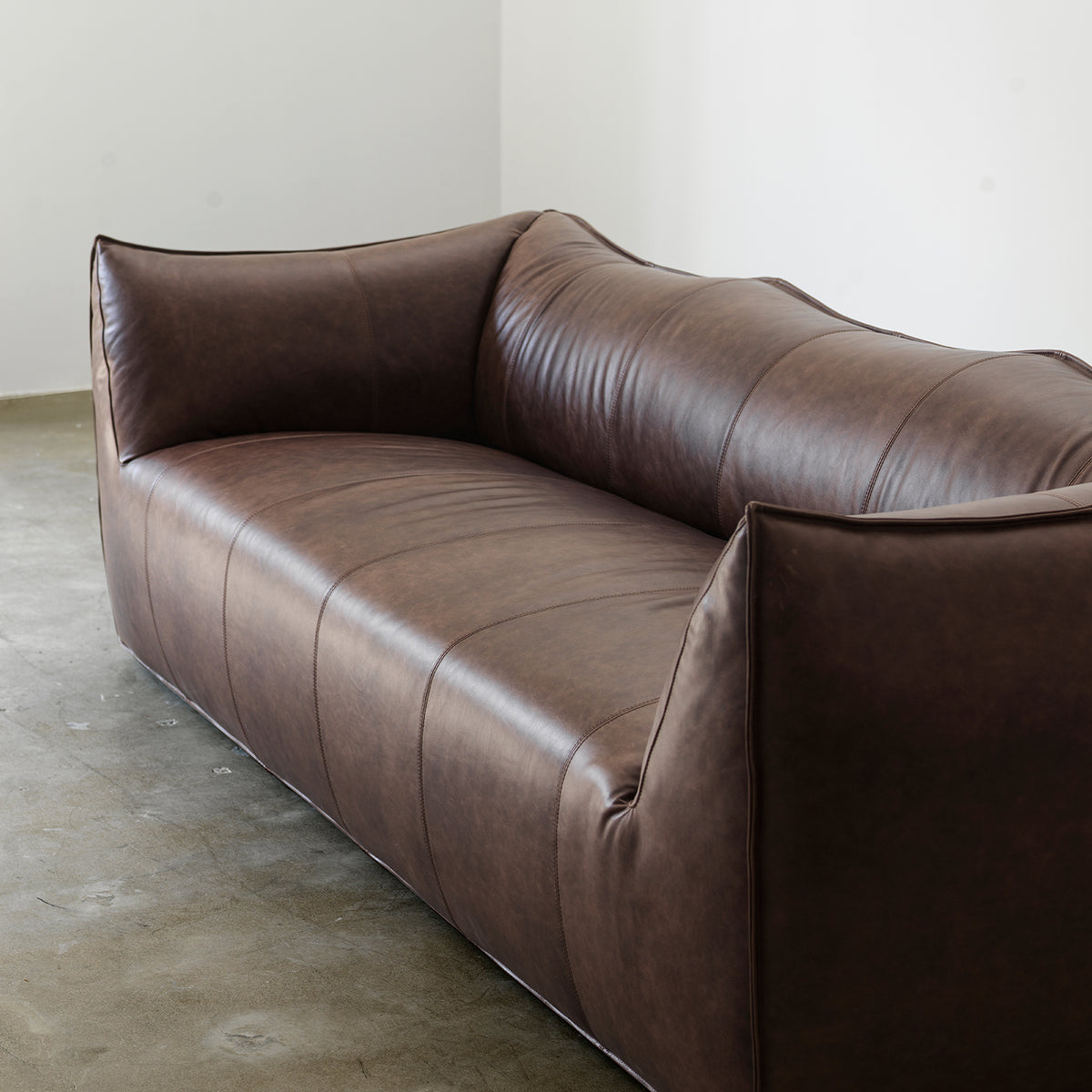Deep brown cowhide leather sofa seat and arm detail