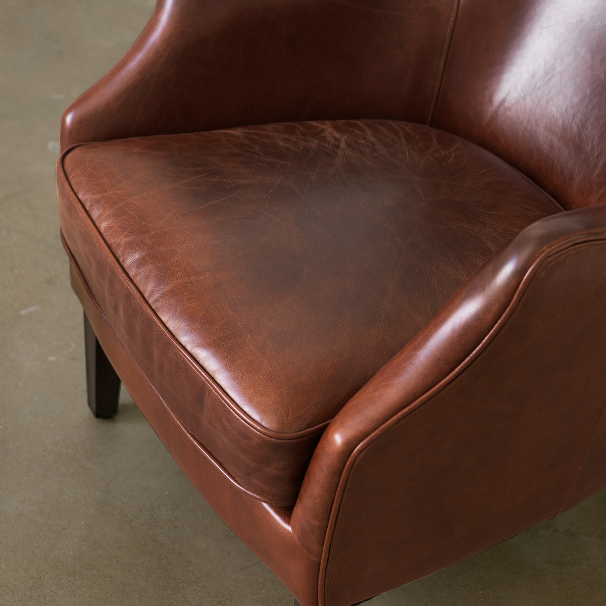 Hand-finished cowhide leather seat and arm detail