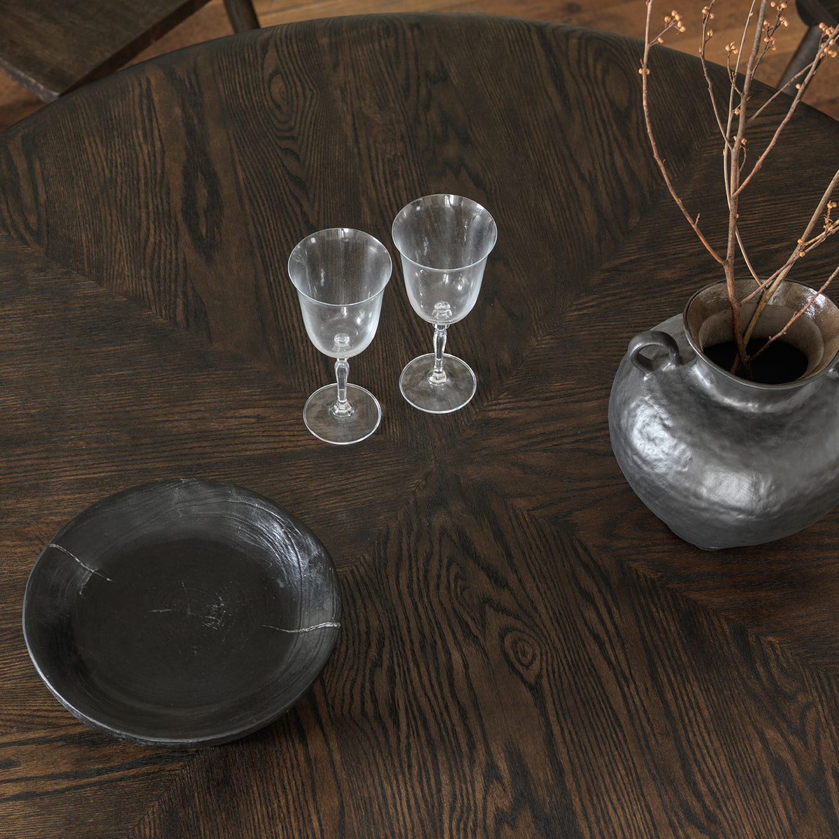 Overhead top-down view of  solid wood round tabletop showing natural wood texture
