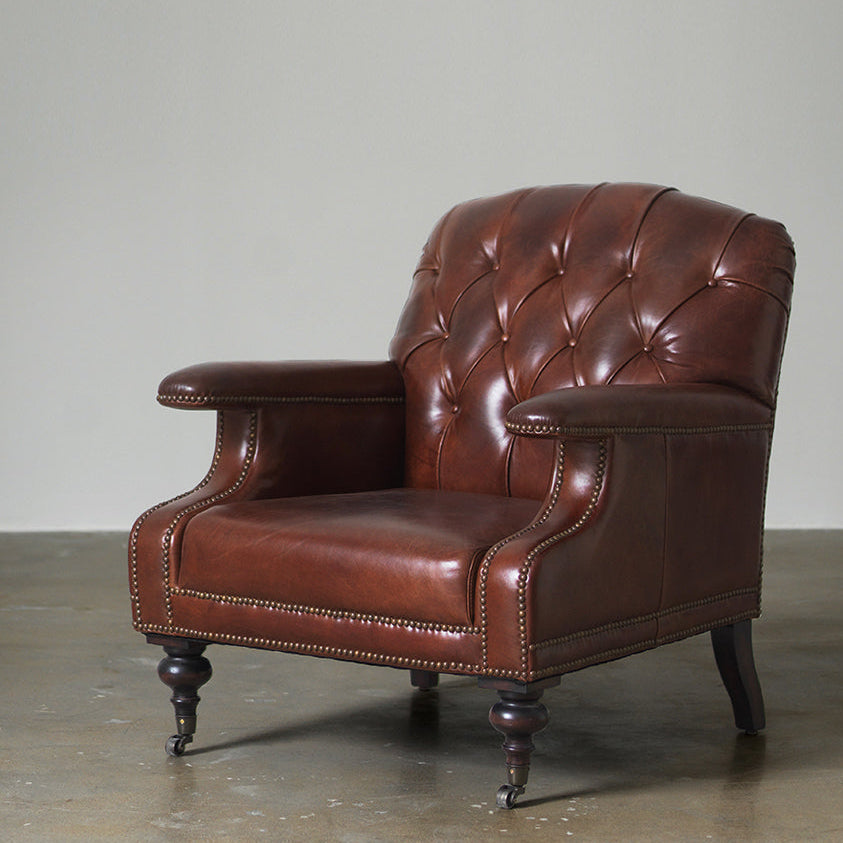 Vintage tufted leather club chair front view