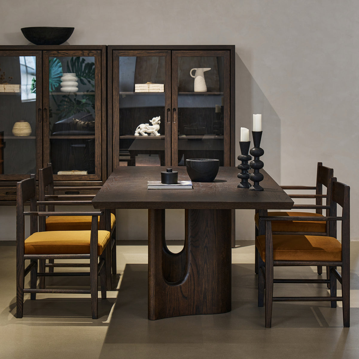 End perspective view of rectangular dining table highlighting table depth and architectural arched cutout base
