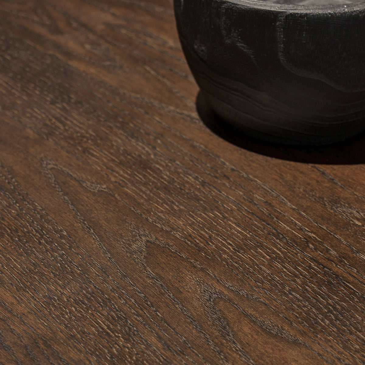 Close-up macro detail of thick red oak wood veneer surface showcasing rich cathedral grain and distressed finish