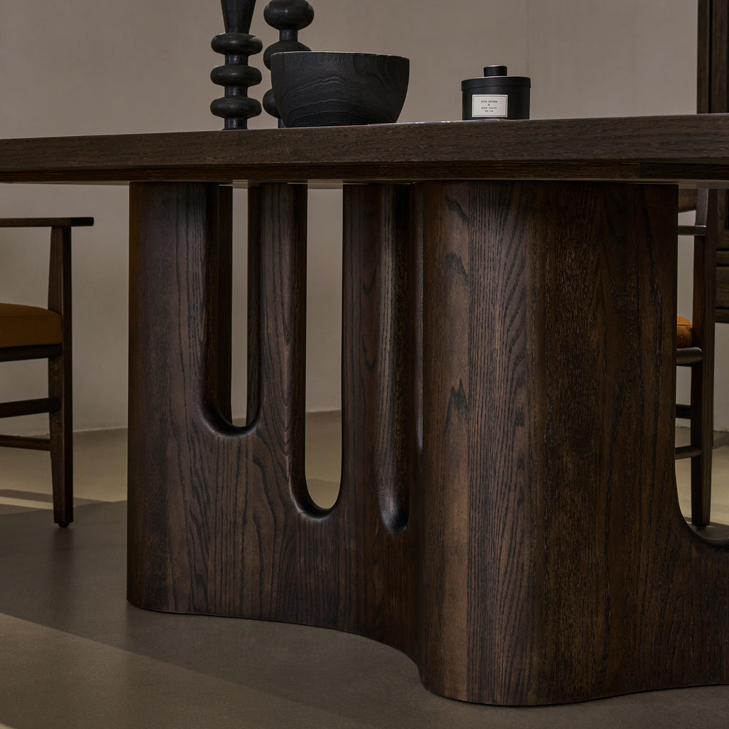 Detailed close-up view of solid red oak pedestal base highlighting smooth carved arches and distressed wood texture