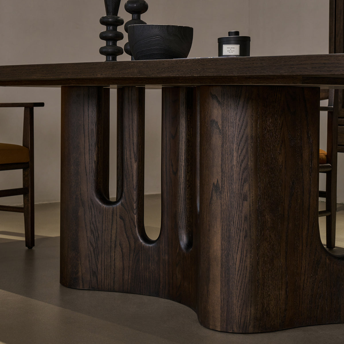 Detailed close-up view of solid red oak pedestal base highlighting smooth carved arches and distressed wood texture
