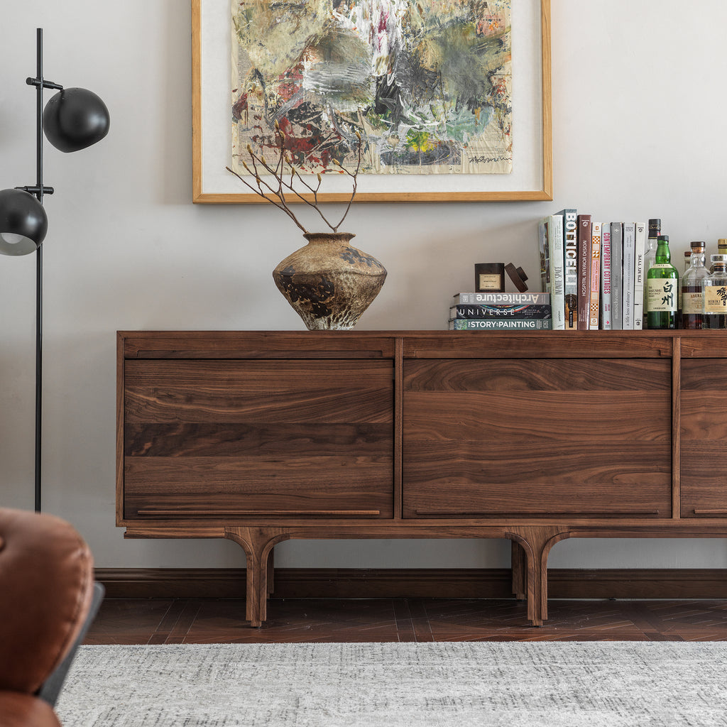 Black walnut sideboard front view beside a black floor lamp in a living room