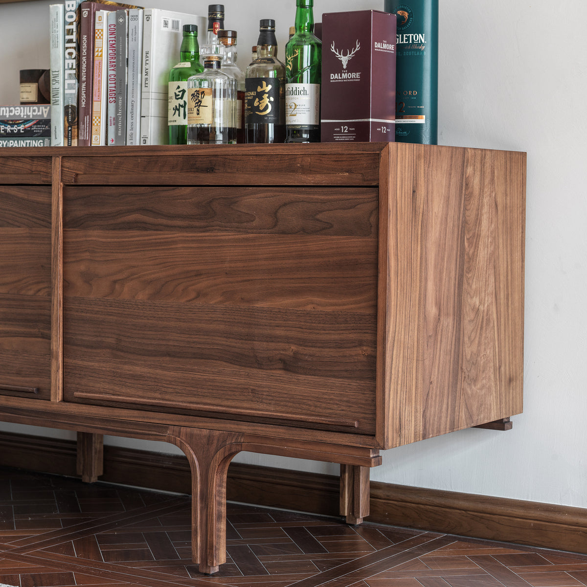  Side view of a black walnut sideboard showing the wood side panel and sculpted leg detail