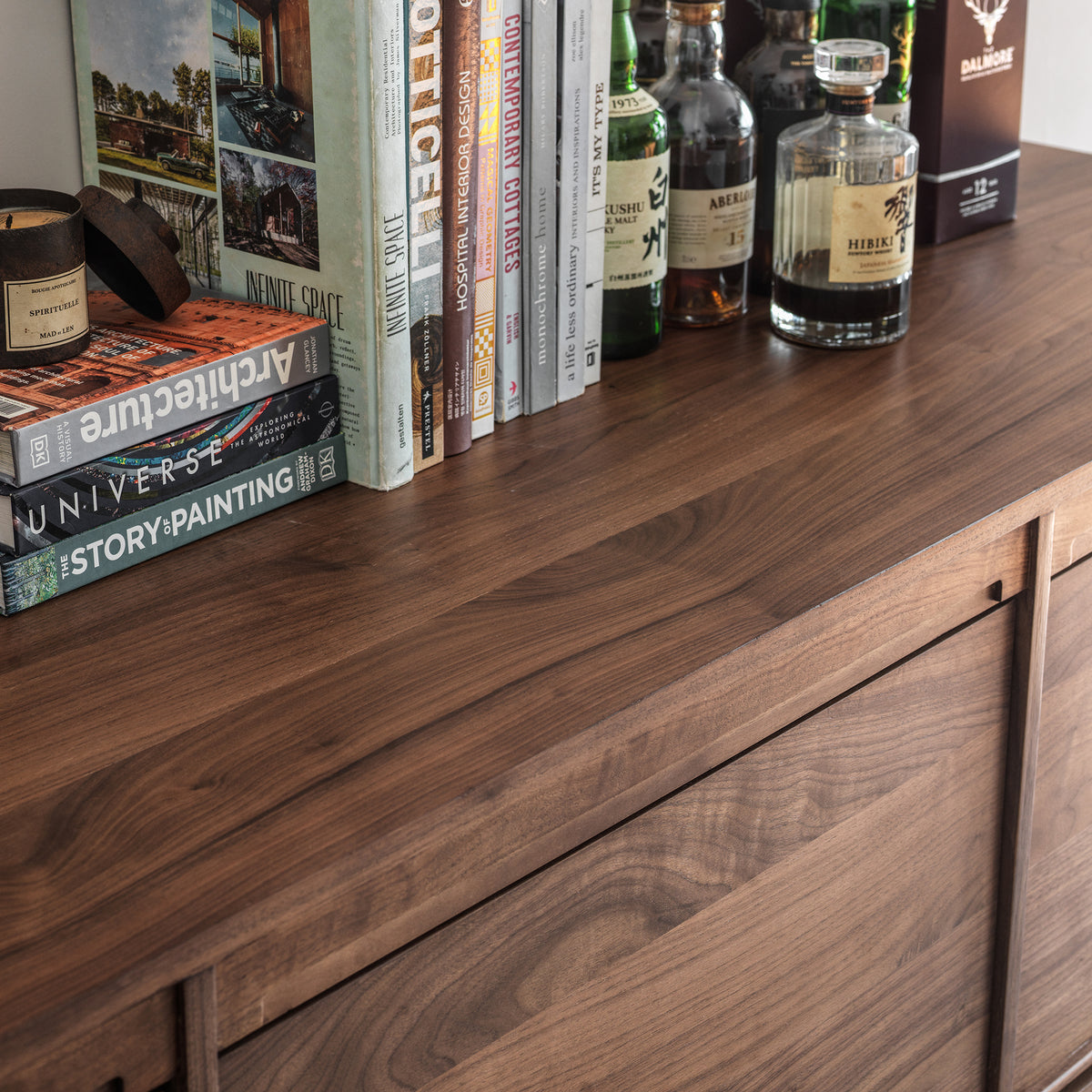 Black walnut wood grain detail on the sideboard top surface and door edge