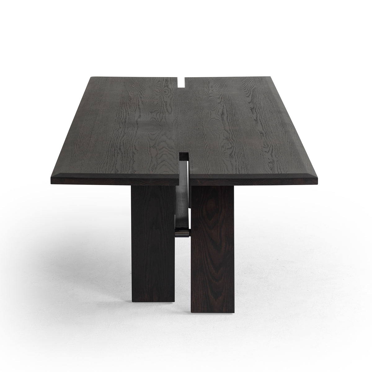 Three-quarter angled view of large solid oak dining table highlighting spacious tabletop and sturdy legs