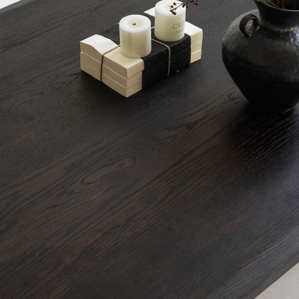Solid red oak distressed dining table styled with chairs in a contemporary open-concept dining room