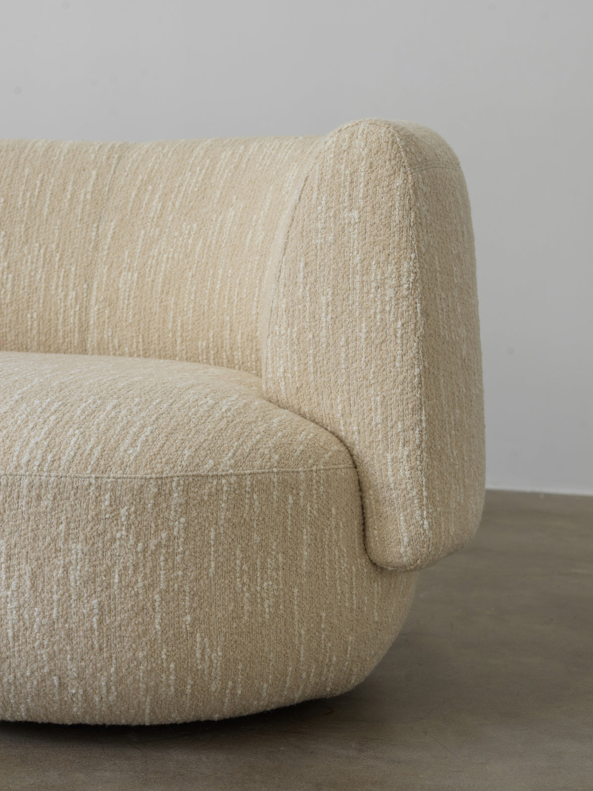 Cream textured fabric sofa upholstery and arm detail