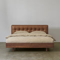 Black walnut bed with tufted cowhide leather headboard front view
