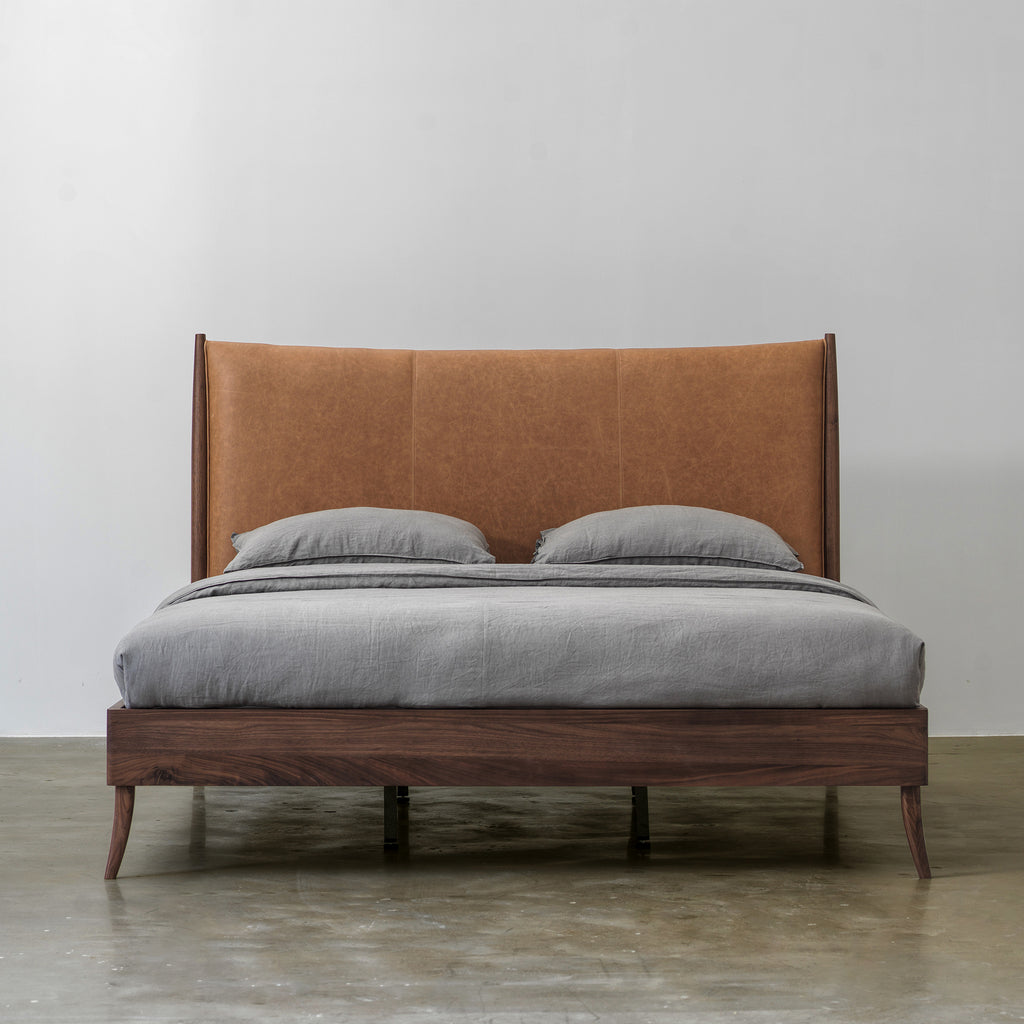 Solid black walnut bed with cowhide leather headboard front view