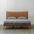 Solid black walnut bed with cowhide leather headboard front view