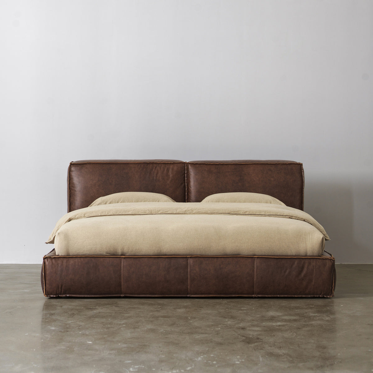 Low-profile cowhide leather upholstered bed front view