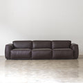 Front view of black low-profile genuine cowhide leather sofa with broad padded arms on white background