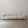 Cream cotton-linen sofa with broad rounded arms front view