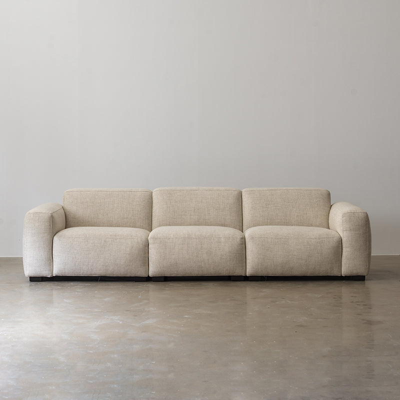 Cream cotton-linen sofa with broad rounded arms front view